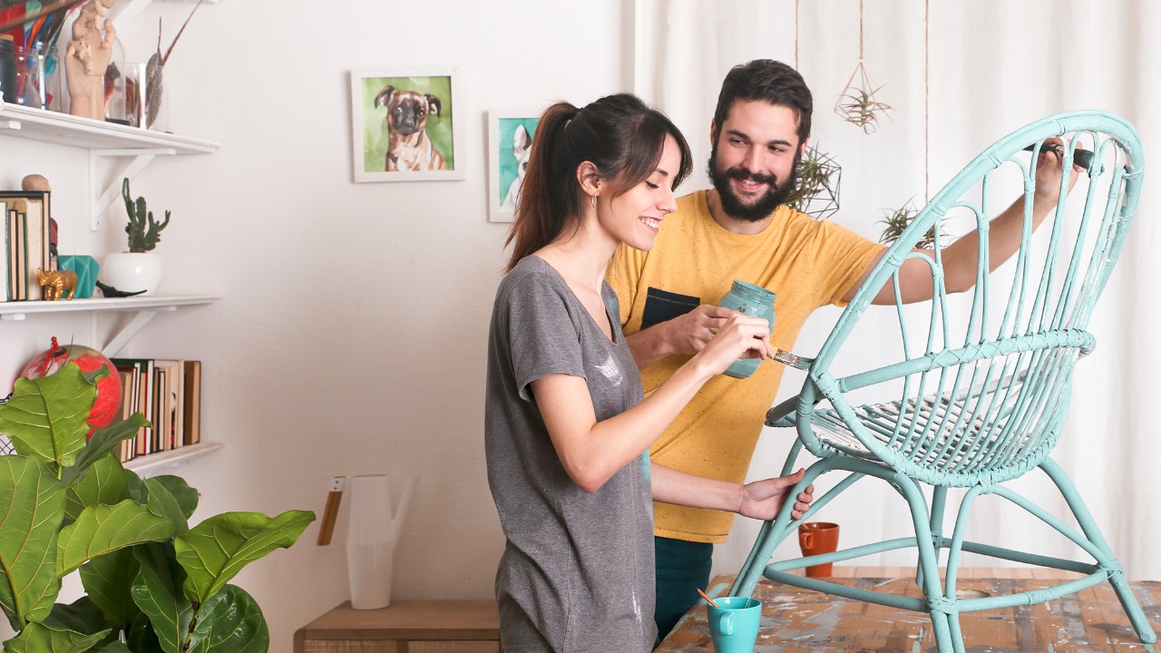 couple painting a chair